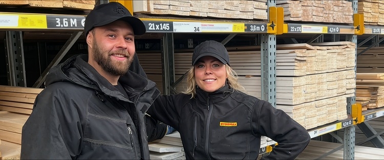 Two employees infront of outside storage